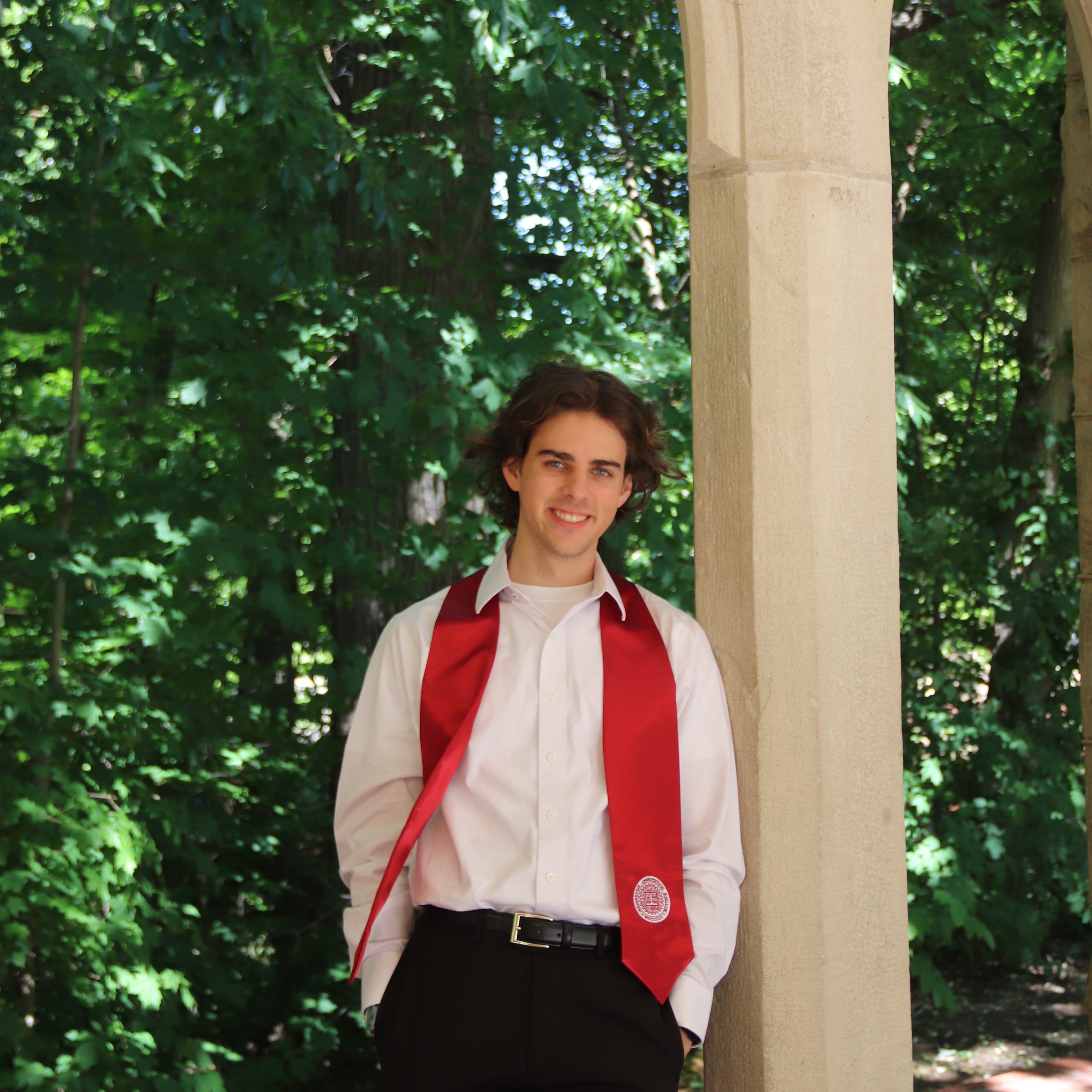 Sean Pletz smiling in graduation attire